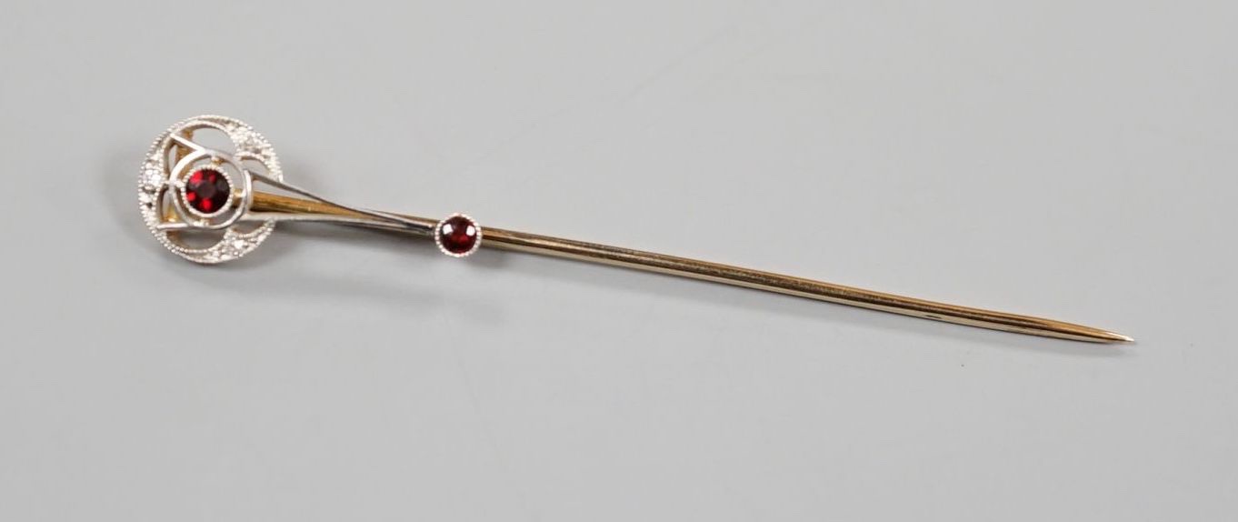 A cased American 14k, garnet and diamond chip set stick pin, by Shreeve & Company, 67mm, gross weight 2.3 grams.